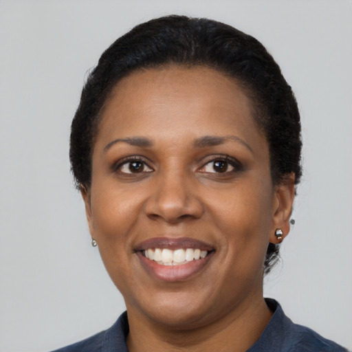 Joyful latino adult female with short  black hair and brown eyes