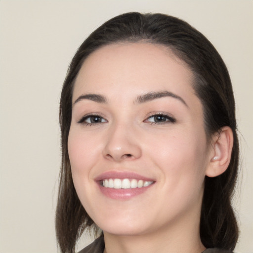 Joyful white young-adult female with medium  black hair and brown eyes