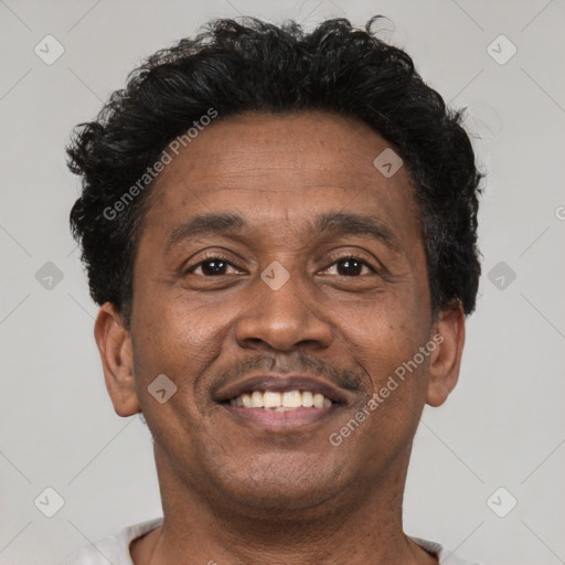 Joyful latino adult male with short  brown hair and brown eyes