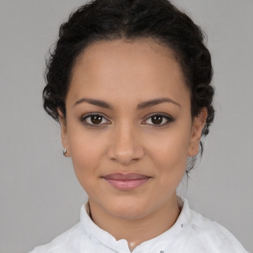 Joyful latino young-adult female with short  brown hair and brown eyes