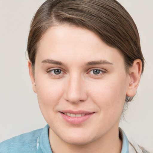 Joyful white young-adult female with short  brown hair and grey eyes