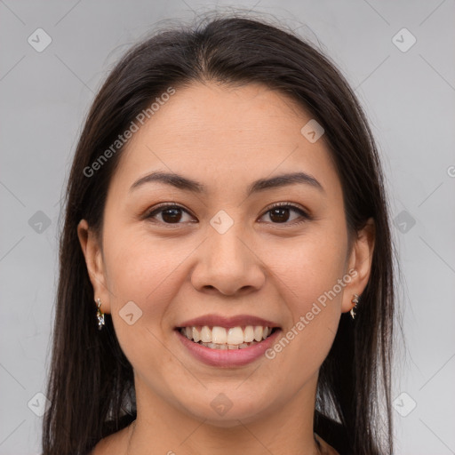 Joyful latino young-adult female with long  brown hair and brown eyes