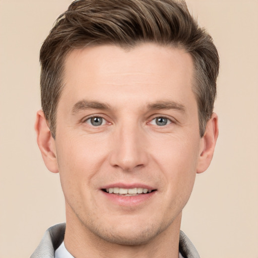 Joyful white young-adult male with short  brown hair and grey eyes