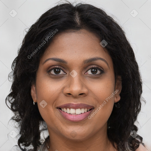 Joyful black young-adult female with long  brown hair and brown eyes