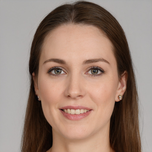 Joyful white young-adult female with long  brown hair and grey eyes