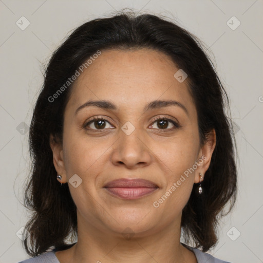 Joyful latino adult female with medium  brown hair and brown eyes