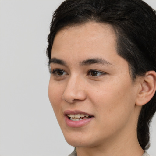 Joyful white young-adult female with medium  black hair and brown eyes