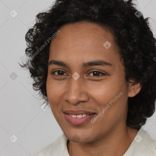 Joyful black young-adult female with long  brown hair and brown eyes