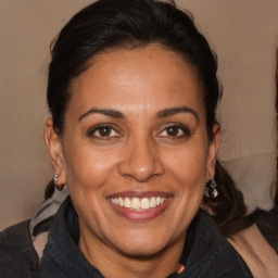 Joyful white adult female with medium  brown hair and brown eyes