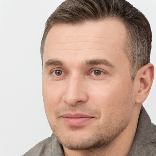 Joyful white adult male with short  brown hair and brown eyes