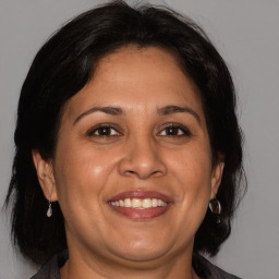 Joyful white adult female with medium  brown hair and brown eyes