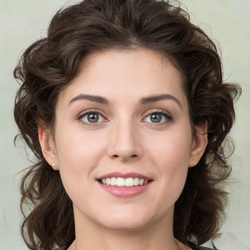 Joyful white young-adult female with medium  brown hair and green eyes