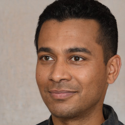 Joyful latino young-adult male with short  black hair and brown eyes