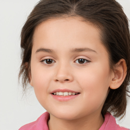 Joyful white child female with medium  brown hair and brown eyes