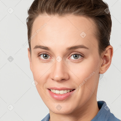 Joyful white young-adult female with short  brown hair and grey eyes