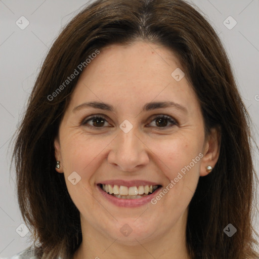 Joyful white adult female with long  brown hair and brown eyes