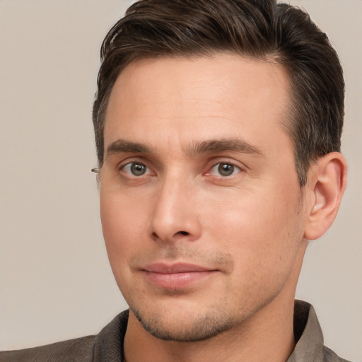 Joyful white young-adult male with short  brown hair and brown eyes