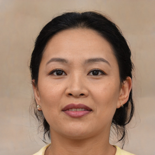 Joyful latino adult female with medium  brown hair and brown eyes