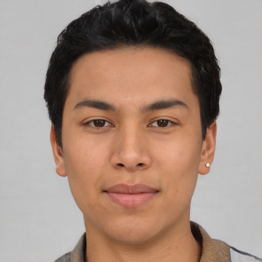 Joyful asian young-adult male with short  black hair and brown eyes