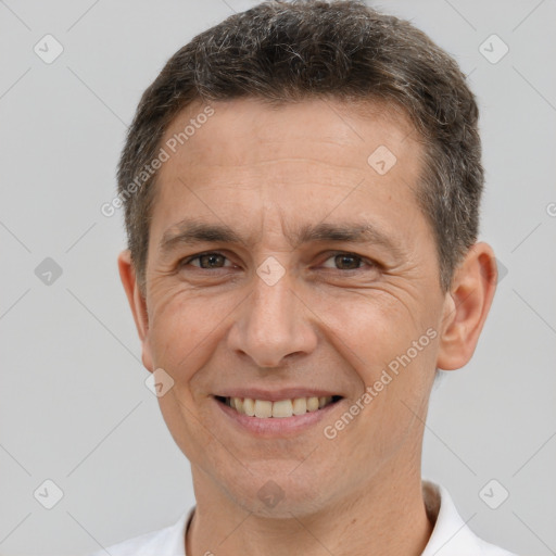 Joyful white adult male with short  brown hair and brown eyes