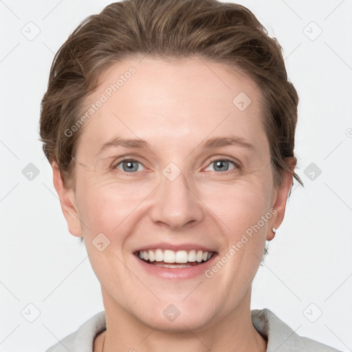 Joyful white adult female with short  brown hair and grey eyes