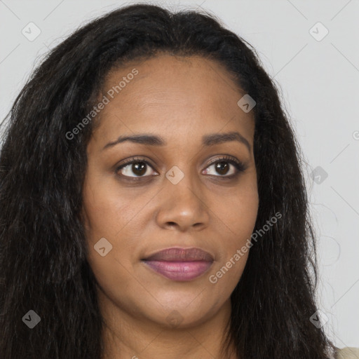 Joyful black young-adult female with long  brown hair and brown eyes