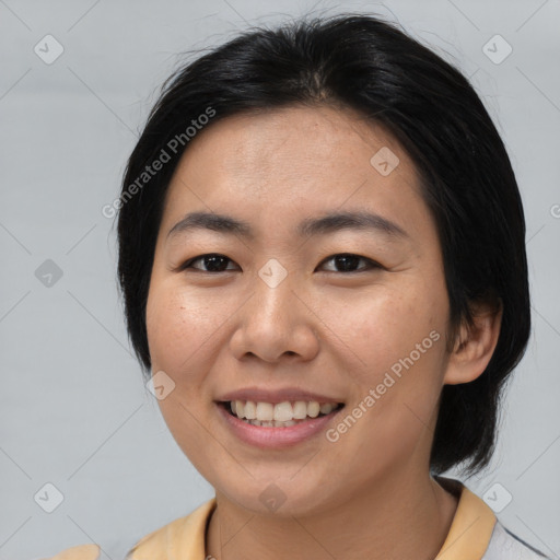 Joyful asian young-adult female with medium  brown hair and brown eyes