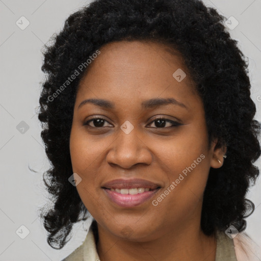 Joyful black young-adult female with long  brown hair and brown eyes