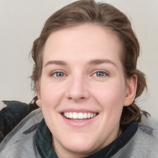 Joyful white young-adult female with medium  brown hair and blue eyes