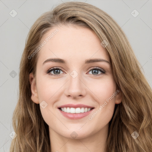 Joyful white young-adult female with long  brown hair and blue eyes