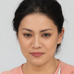 Joyful latino young-adult female with medium  brown hair and brown eyes