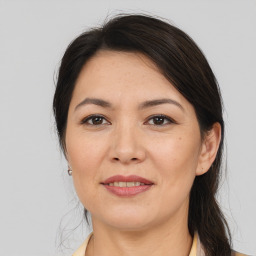 Joyful asian adult female with medium  brown hair and brown eyes