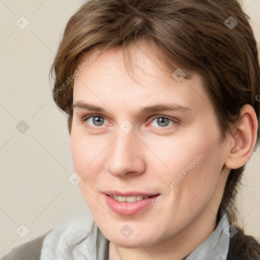 Joyful white young-adult female with medium  brown hair and grey eyes