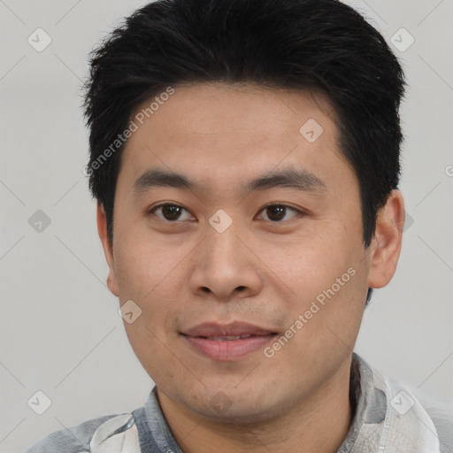 Joyful asian young-adult male with short  black hair and brown eyes