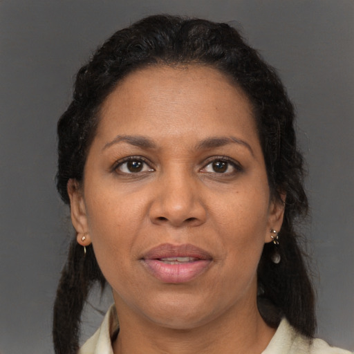 Joyful black adult female with medium  brown hair and brown eyes