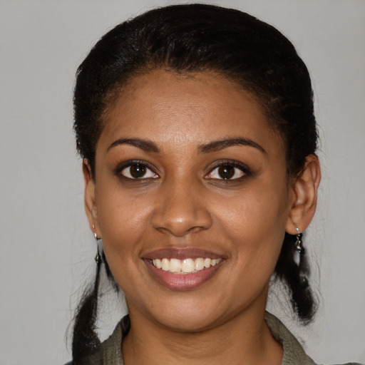 Joyful latino young-adult female with short  black hair and brown eyes