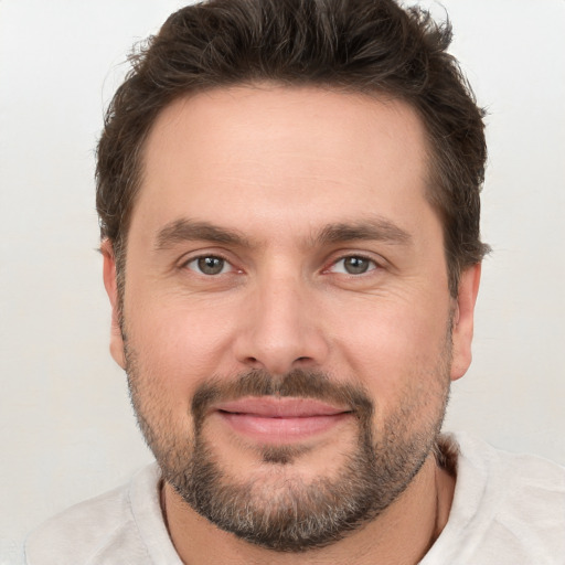 Joyful white adult male with short  brown hair and brown eyes