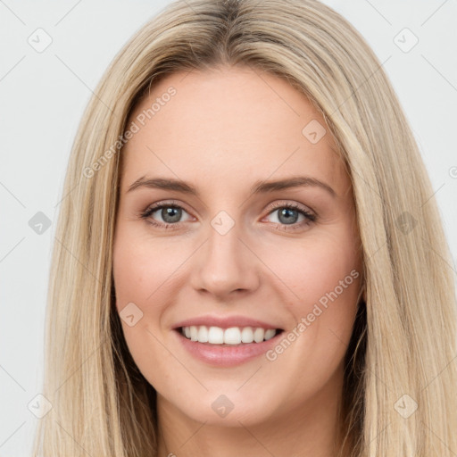 Joyful white young-adult female with long  brown hair and green eyes