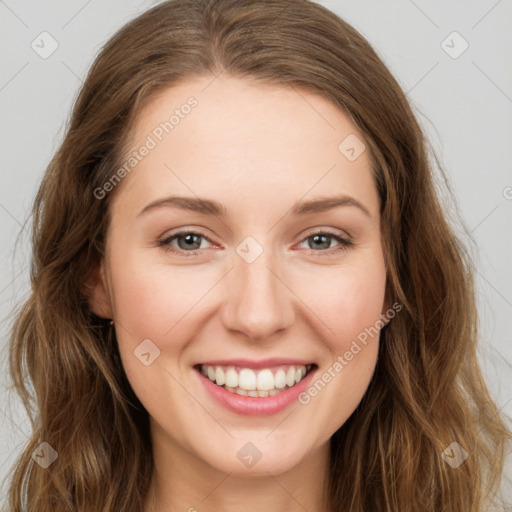 Joyful white young-adult female with long  brown hair and green eyes