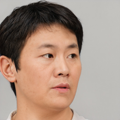 Neutral asian young-adult male with short  brown hair and brown eyes