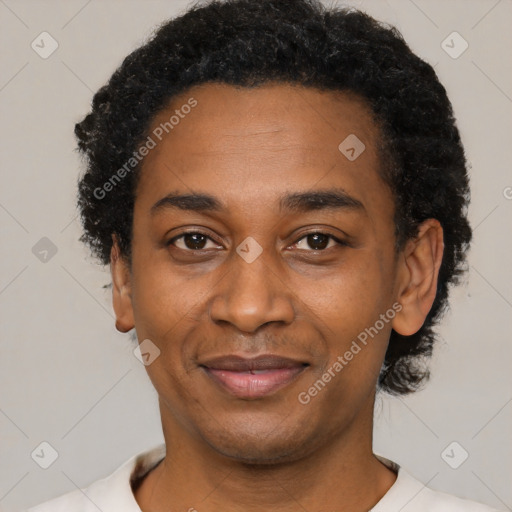 Joyful black adult male with short  black hair and brown eyes