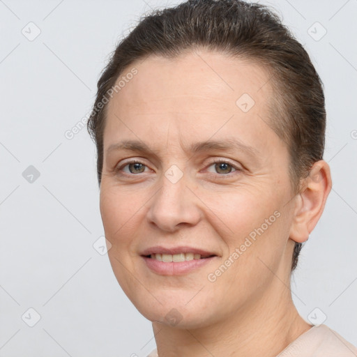 Joyful white adult female with short  brown hair and brown eyes