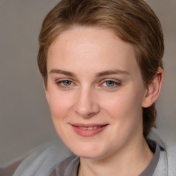 Joyful white young-adult female with medium  brown hair and blue eyes