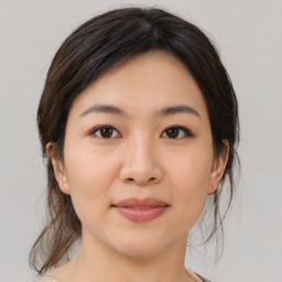 Joyful asian young-adult female with medium  brown hair and brown eyes