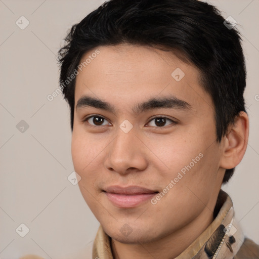 Joyful latino young-adult male with short  brown hair and brown eyes