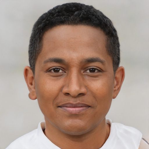 Joyful black young-adult male with short  brown hair and brown eyes