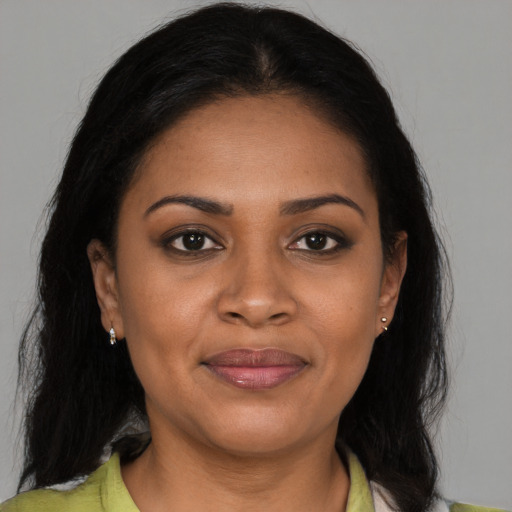 Joyful black young-adult female with medium  brown hair and brown eyes
