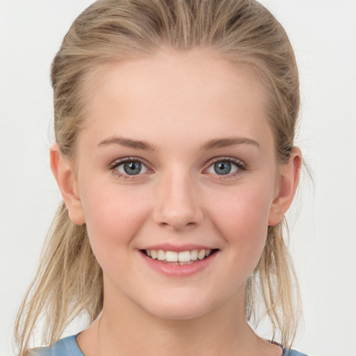 Joyful white young-adult female with medium  brown hair and blue eyes