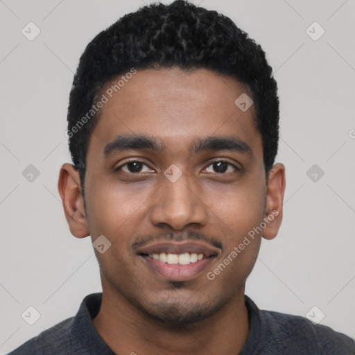 Joyful black young-adult male with short  black hair and brown eyes
