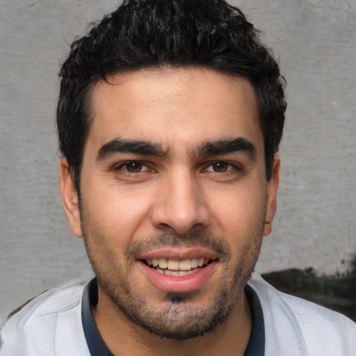 Joyful white young-adult male with short  black hair and brown eyes